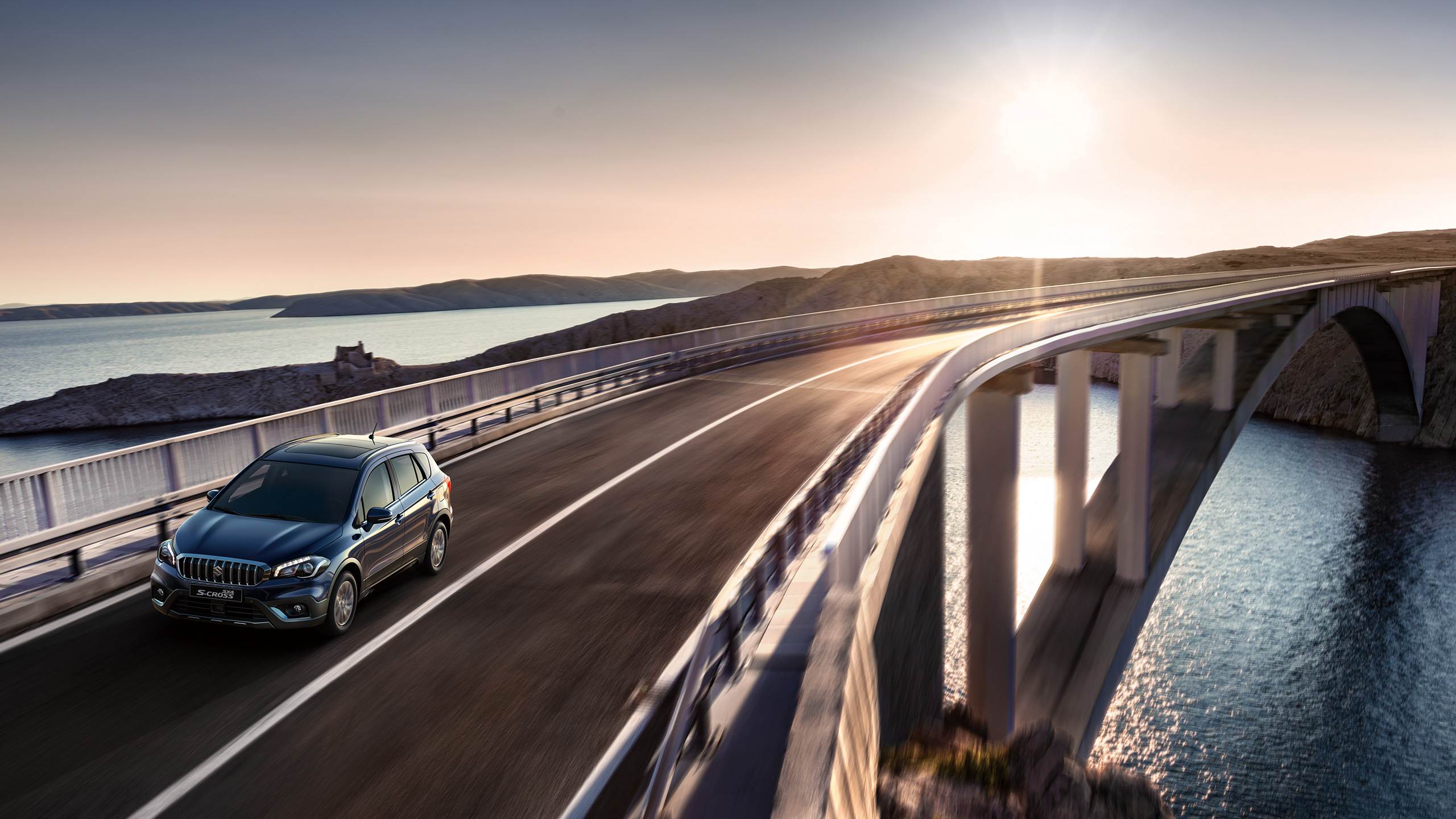 SX4-S-CROSS-driving-on-long-bridge-with-sunset