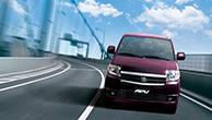 Front-view-of-a-purple-APV-driving-on-the-high-way