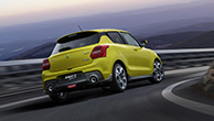 rear-shot-of-Swift-Sport-going-through-a-curve-on-mountain-road