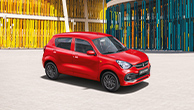 Red-Suzuki-Celerio-standing-in-front-of-a-colourful-architecture