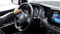 A-man-holding-Suzuki-Ertiga's-steering-and-gear