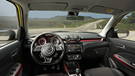 Swift-Sport-interior-showing-instrument-panel-with-highway-outside