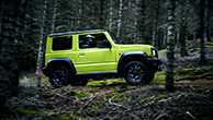 Side-view-of-Jimny-driving-through-the-woods